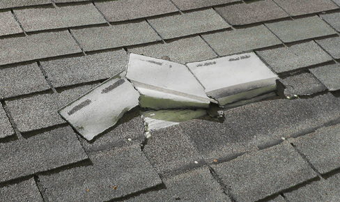 Damaged shingles on a roof.